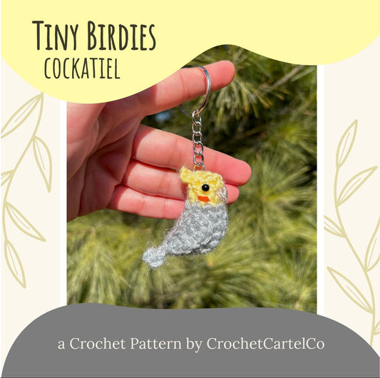 Crochet Cockatiel keychain crochet pattern shown held by a hand with a natural background