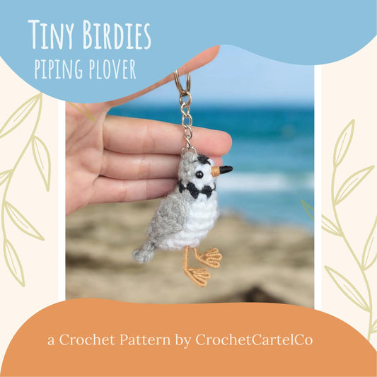 Crocheted piping plover bird keychain crochet pattern shown held in a hand with ocean background