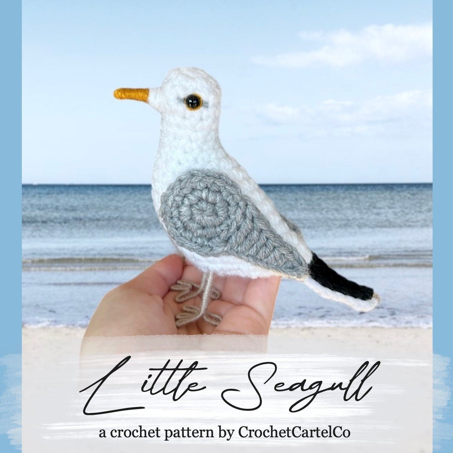 Crocheted seagull crochet pattern shown held by a hand with a beach background, featuring 'Little Seagull' by CrochetCartelCO