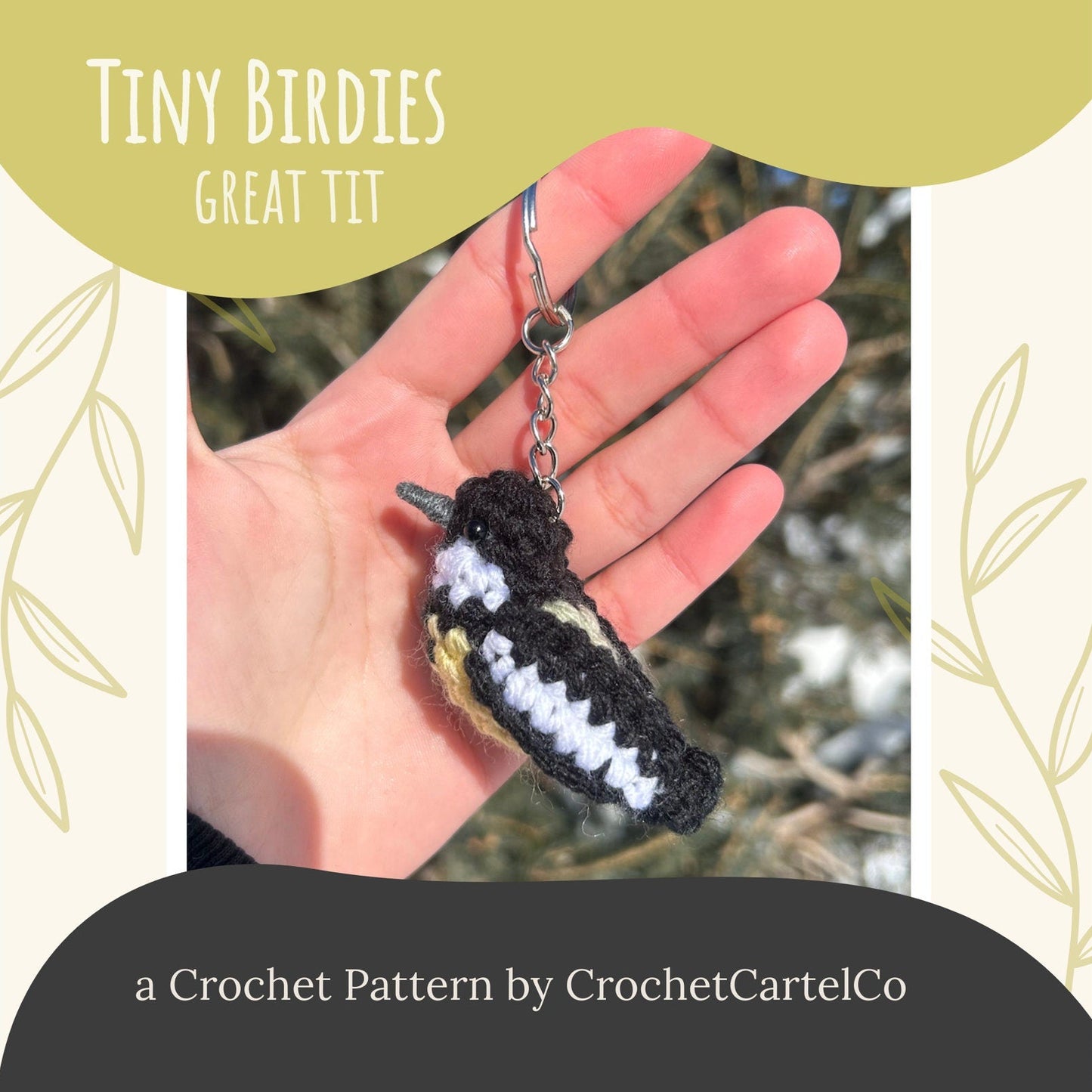 Crocheted bird keychain held in a hand with 'Tiny Birdies Great Tit Crochet Pattern' text and CrochetCartelCo branding.