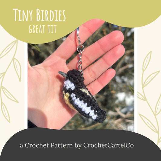 Crocheted bird keychain held in a hand with 'Tiny Birdies Great Tit Crochet Pattern' text and CrochetCartelCo branding.