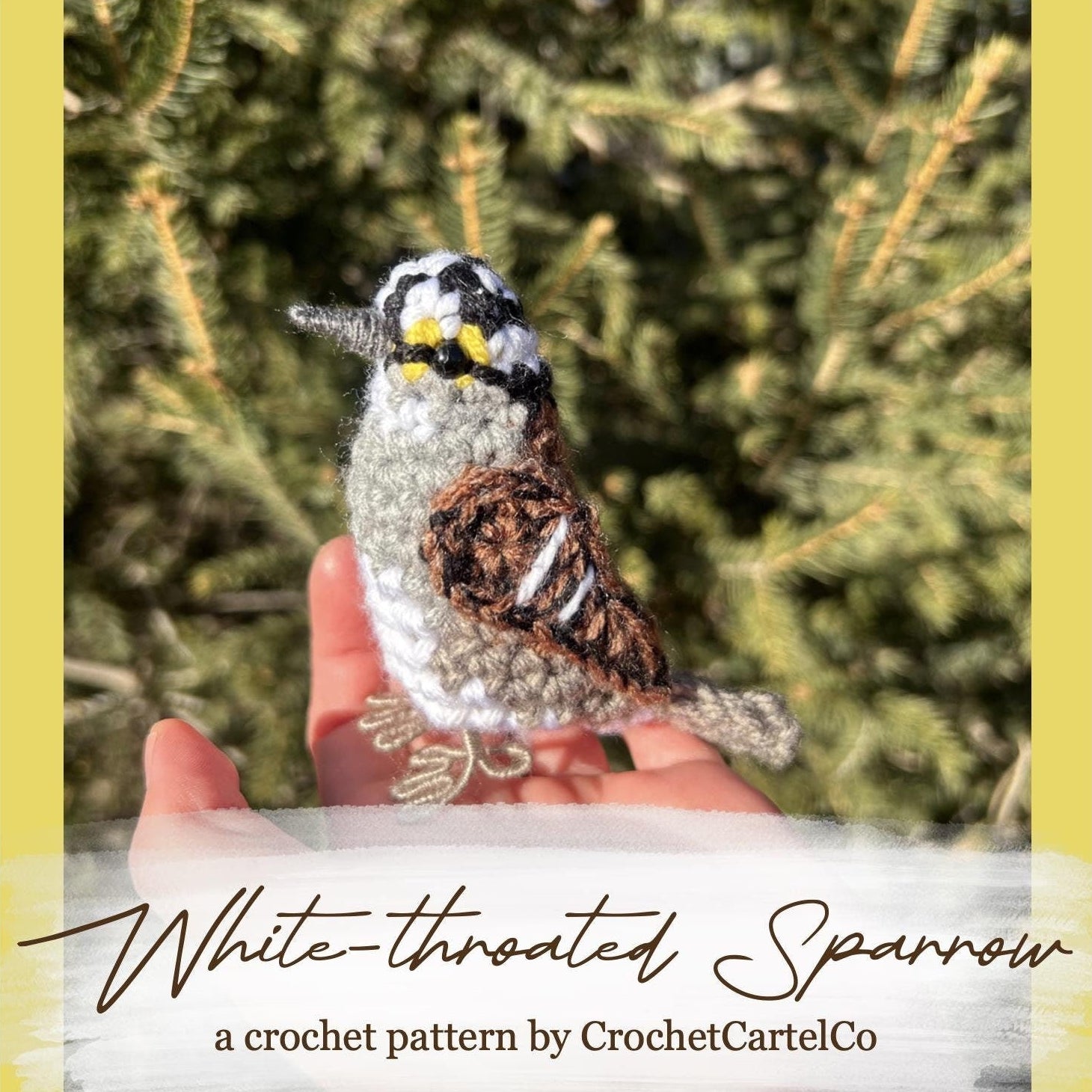 Hand holding a crochet white-throated sparrow in front of green foliage, with text about a crochet pattern by CrochetCartelCo.