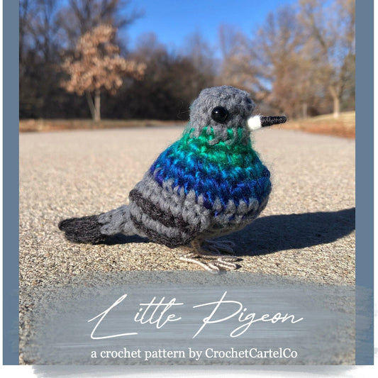 Crochet pattern for a pigeon on a gravel surface with trees in the background