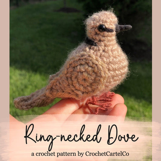 Crocheted ring-necked dove crochet pattern shown held in a hand with grass background