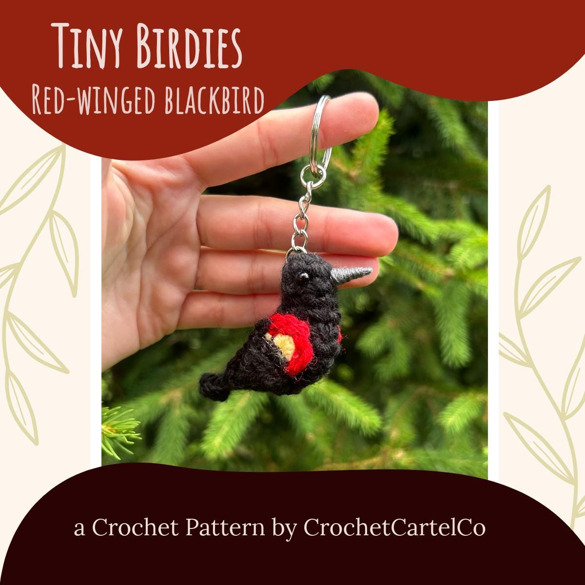 A crochet red-winged blackbird keychain crochet pattern shown against a green tree background