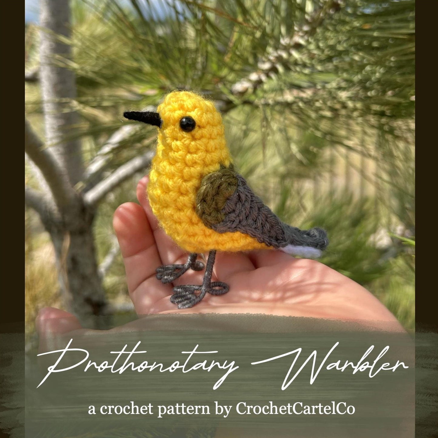 Crocheted Prothonotary Warbler patterm held in a hand with a natural background