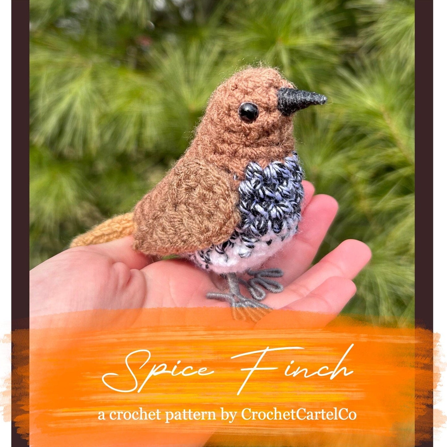 Crocheted Spice Finch crochet pattern, shown held in a hand with a blurred green background