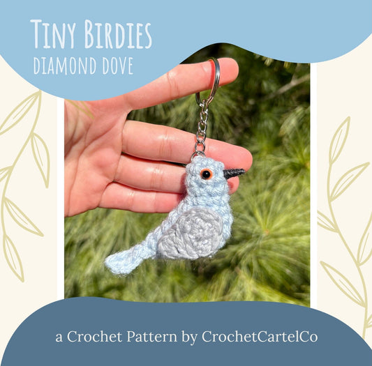Crocheted bird keychain crochet pattern, shown held by a hand with a natural background