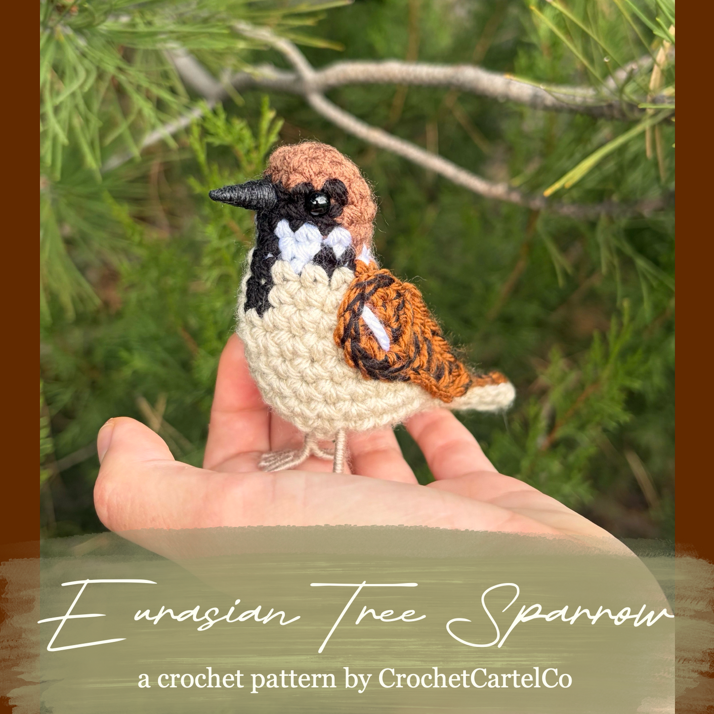 A crocheted bird figurine resembling a Eurasian Tree Sparrow is displayed on a person's hand against a blurred outdoor background of green foliage and branches. The text overlay at the bottom reads 'Eurasian Tree Sparrow' and 'a crochet pattern by CrochetCartelCo'.