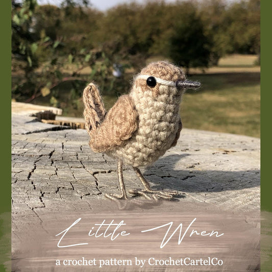 Crocheted bird pattern shown on a wooden log with a natural background