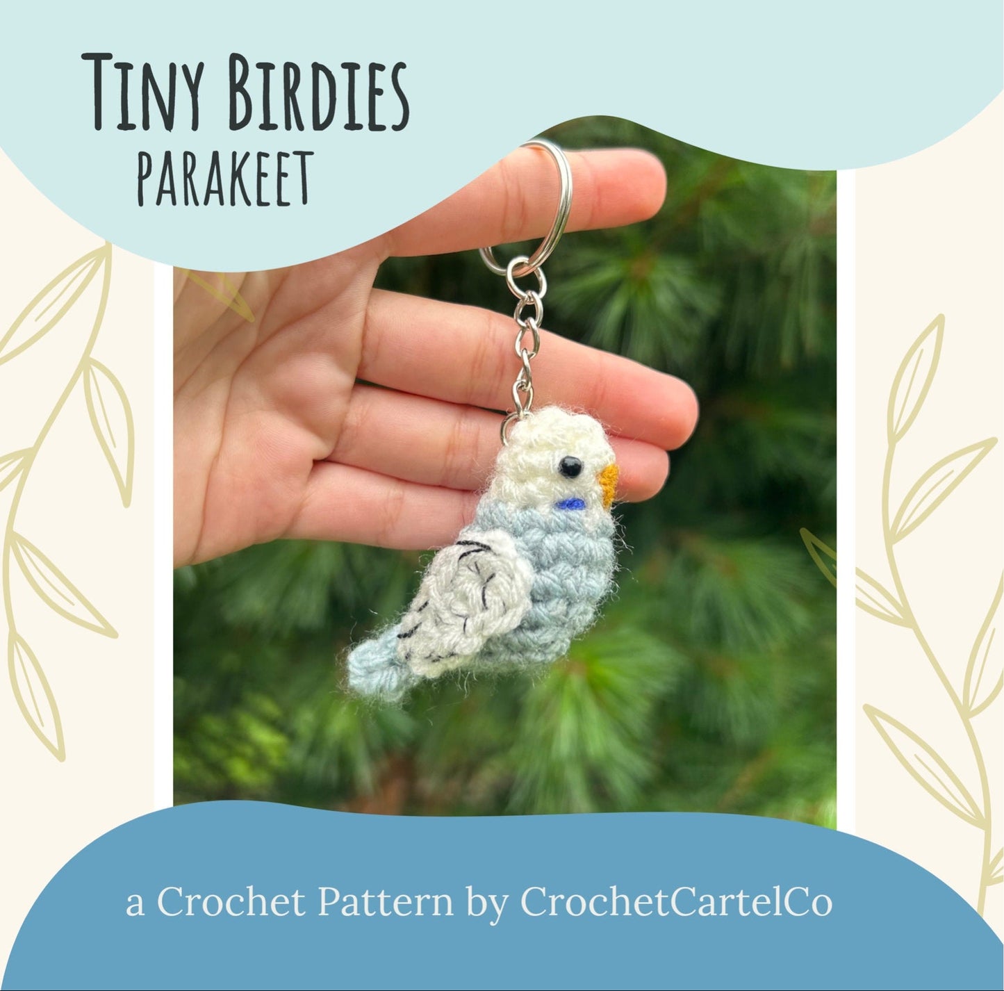Crocheted parakeet keychain crochet pattern shown held in a hand with a natural background