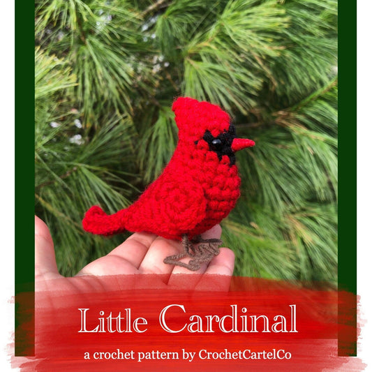 Crochet pattern for a red cardinal held in a hand with a green leafy background
